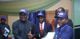 The NDDC Acting Managing Director, Engr. Emmanuel Audu-Ohwavborua, (left) presenting a certificate to one of the participants, Mr. Paul Ijeh, (right) during the graduation ceremony of the NDDC/ESI Entrepreneurial Development Scheme, in Port Harcourt. In the middle is the NDDC Director Commercial and Industrial Development, CID, Mr. Messiah Obuzor