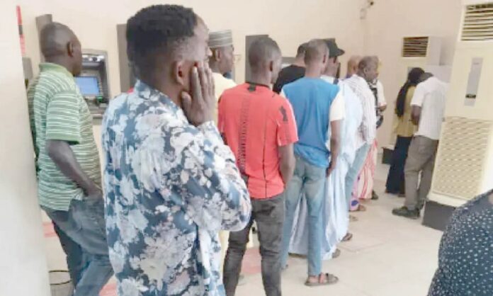 Nigerians withdraw cash from banks cash